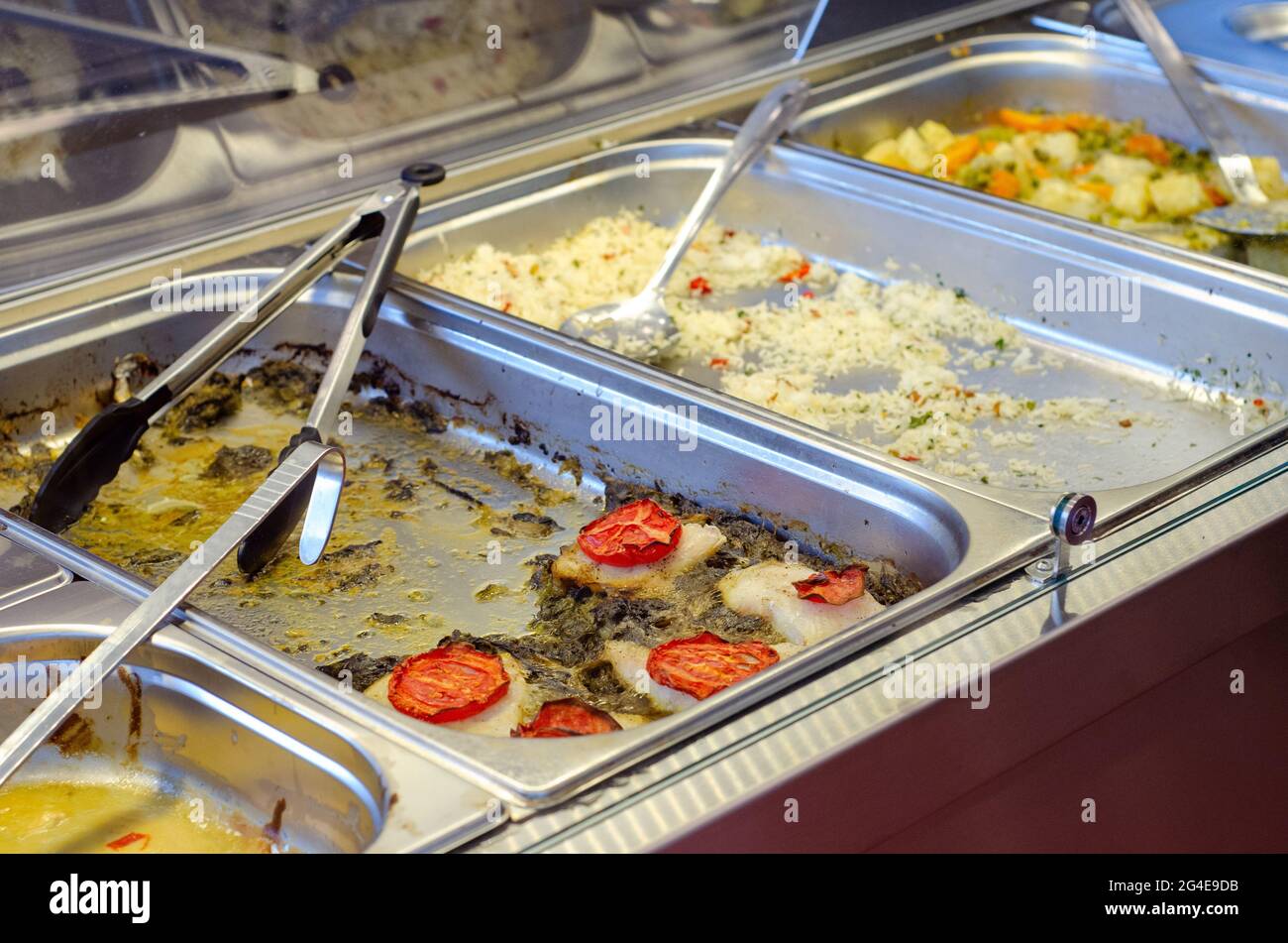 A catering bainmarie with empty leftover foods displayed in a