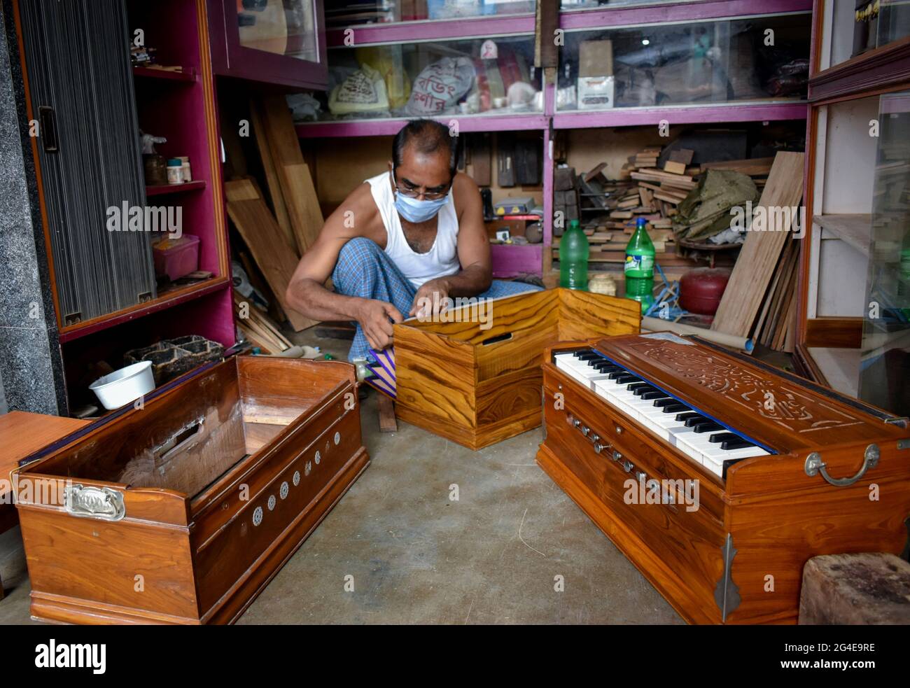 Kolkata, India. 20th June, 2021. A person is making a musical instrument Harmonium (A classical
