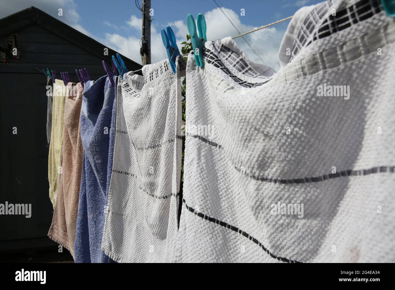 Laundry drying pegged to clothesline hires stock photography and