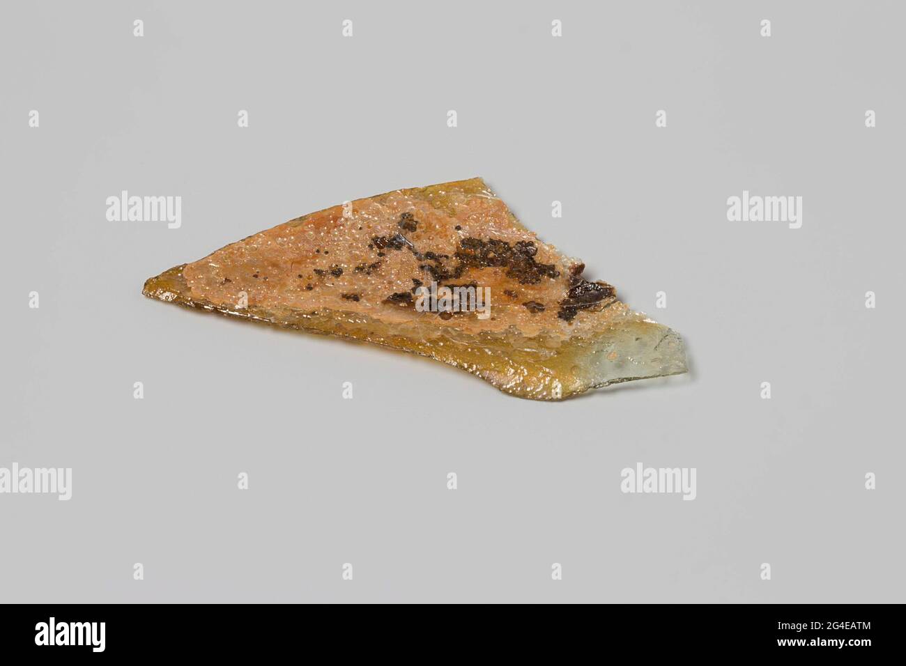 Fragment of a wine bottle from the wreck of the East India Flying Heart. Dispiled glass shard. Stock Photo