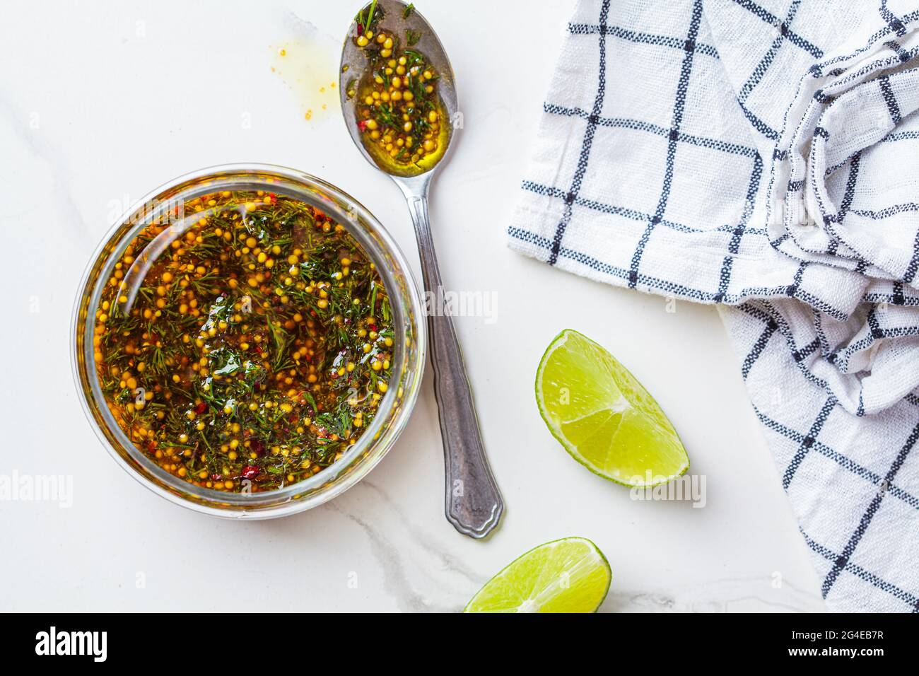 Mustard, olive oil and dill salad dressing in a glass jar, top view. Cooking healthy food concept. Stock Photo