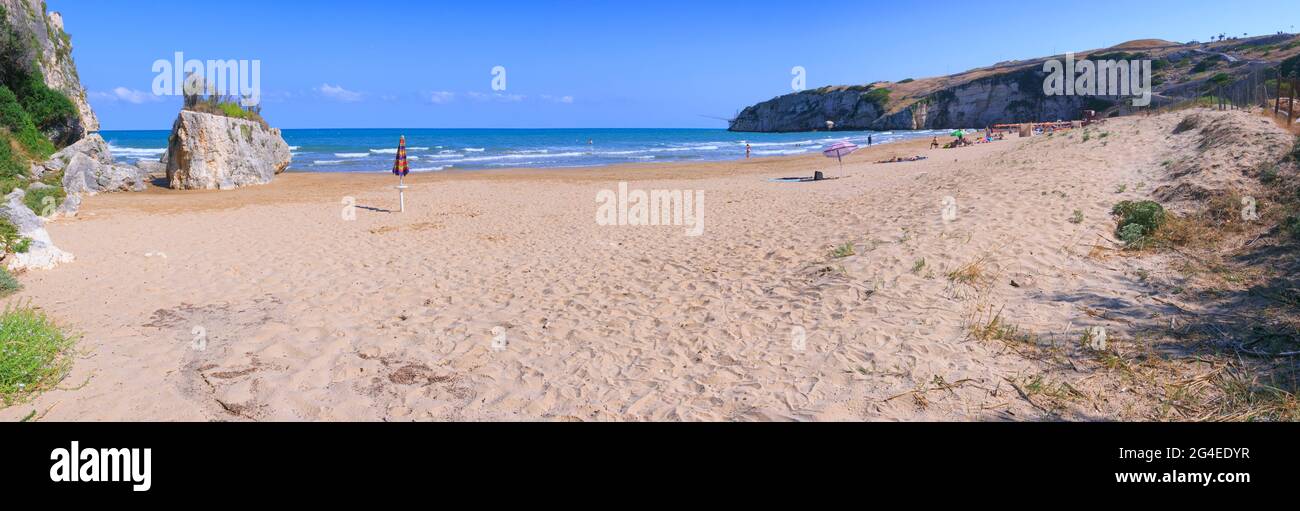 The most beautiful beaches of Apulia: Zaiana Bay, enclosed by two rocks, stretches a few kilometres away from Peschici, in Gargano, Italy. Stock Photo