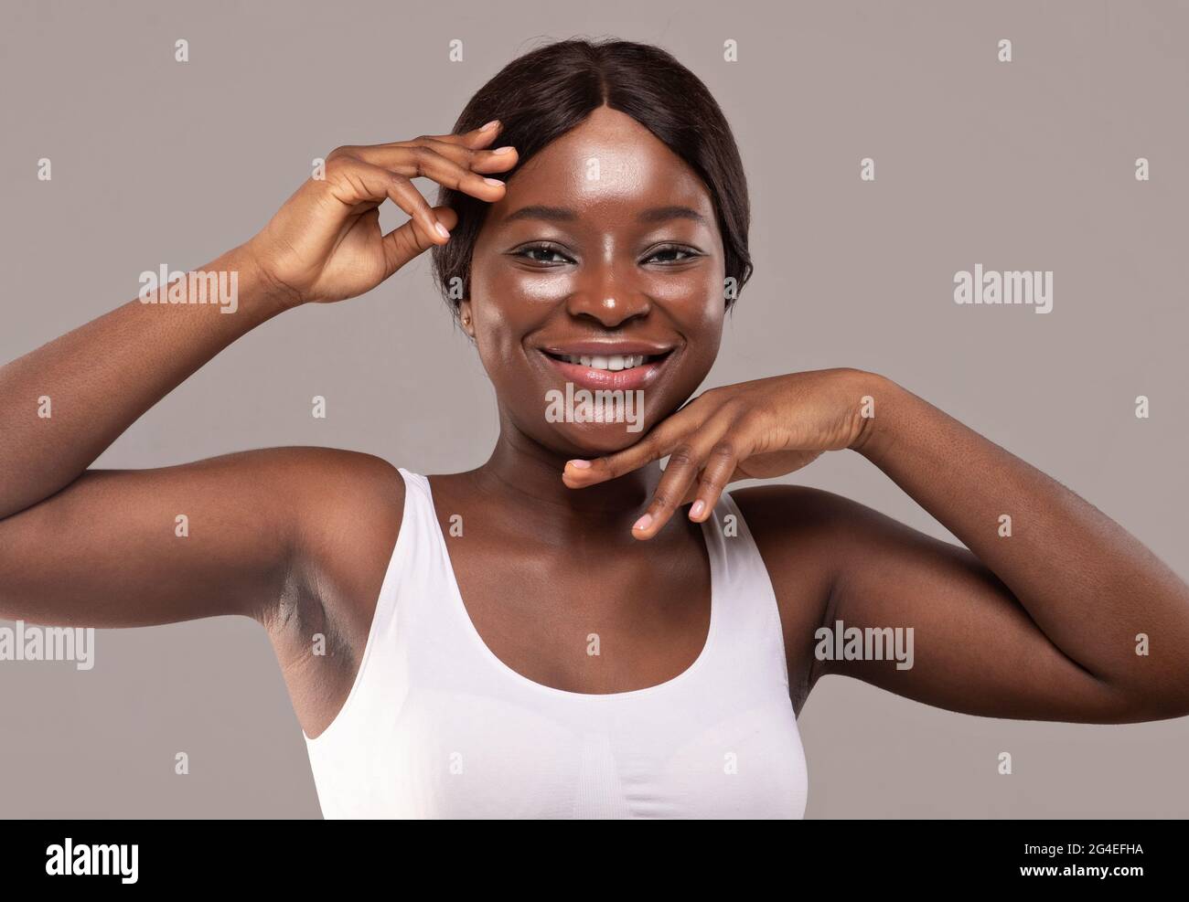 Essential Beauty. Beauty Portrait Of Happy Young African Female With Flawless Skin Stock Photo