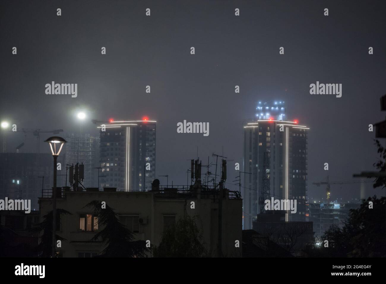 Picture of old and new buildings in belgrade, serbia, during a smoggy foggy night due to pollution. Belgrade, Serbia, is victime of pollution issues i Stock Photo