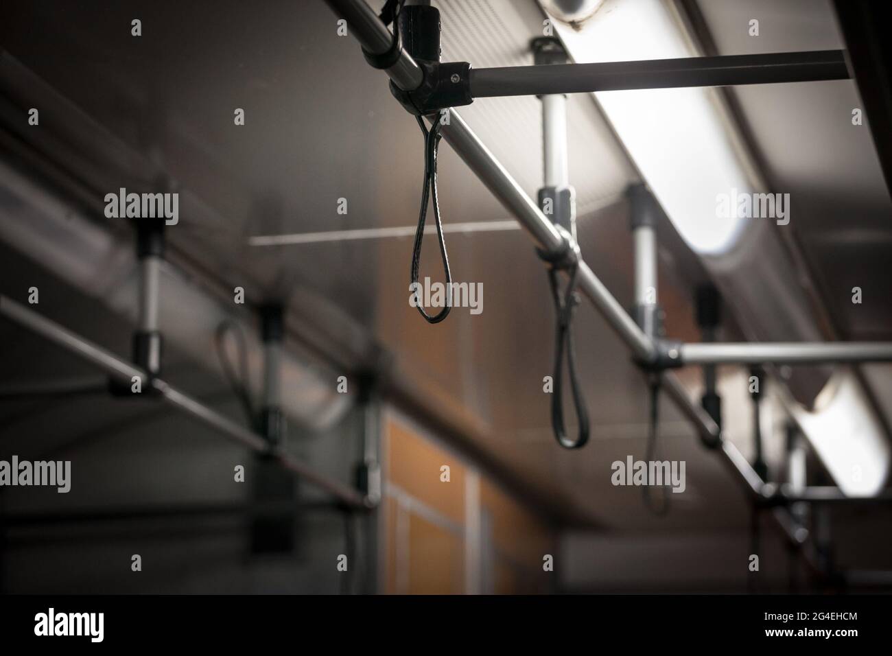 Picture of a grab handle in a suburban train, inside, with nobody