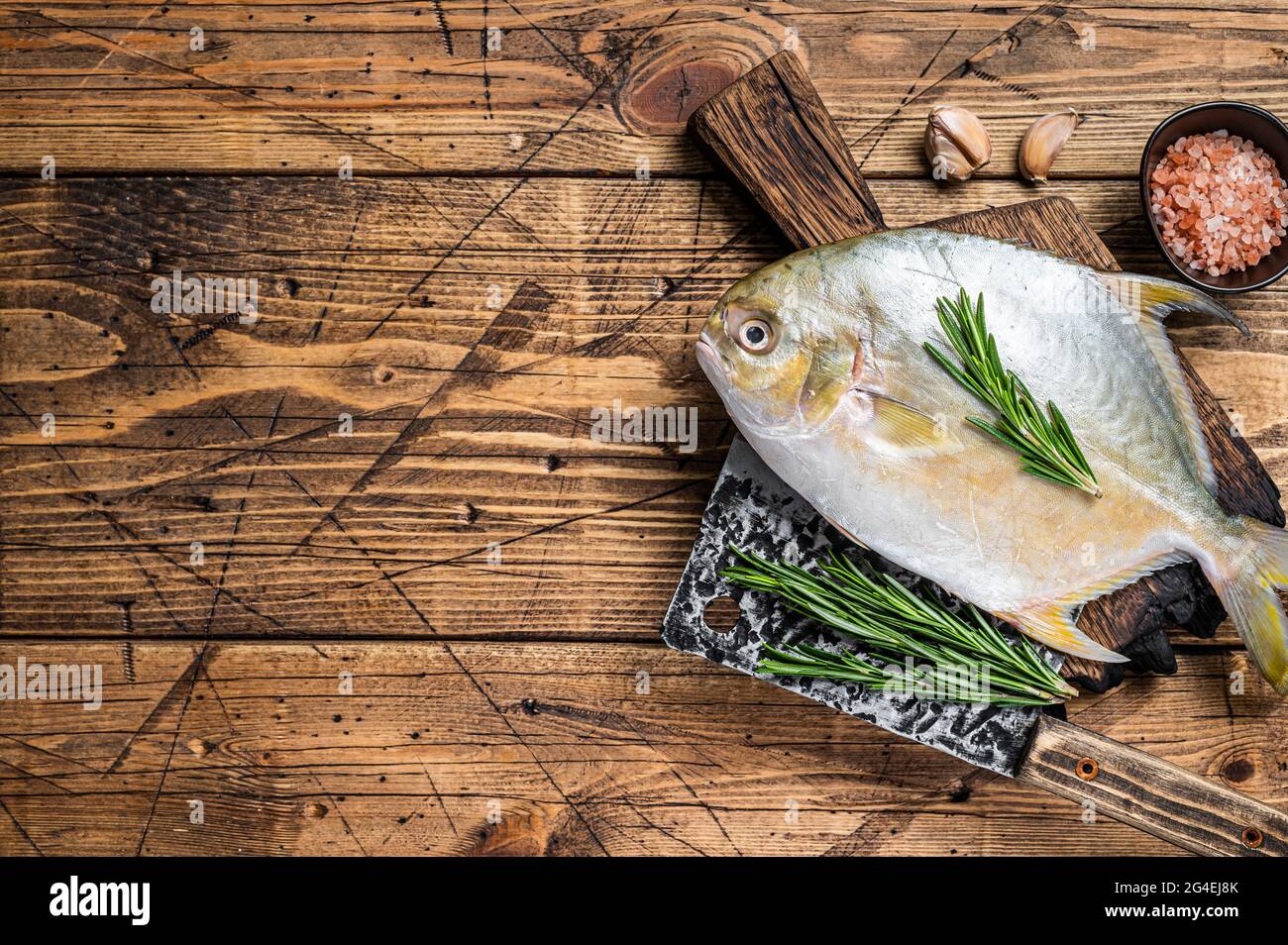 Raw fish Sunfish or pompano on a wooden board. wooden background. Top view. Copy space Stock Photo