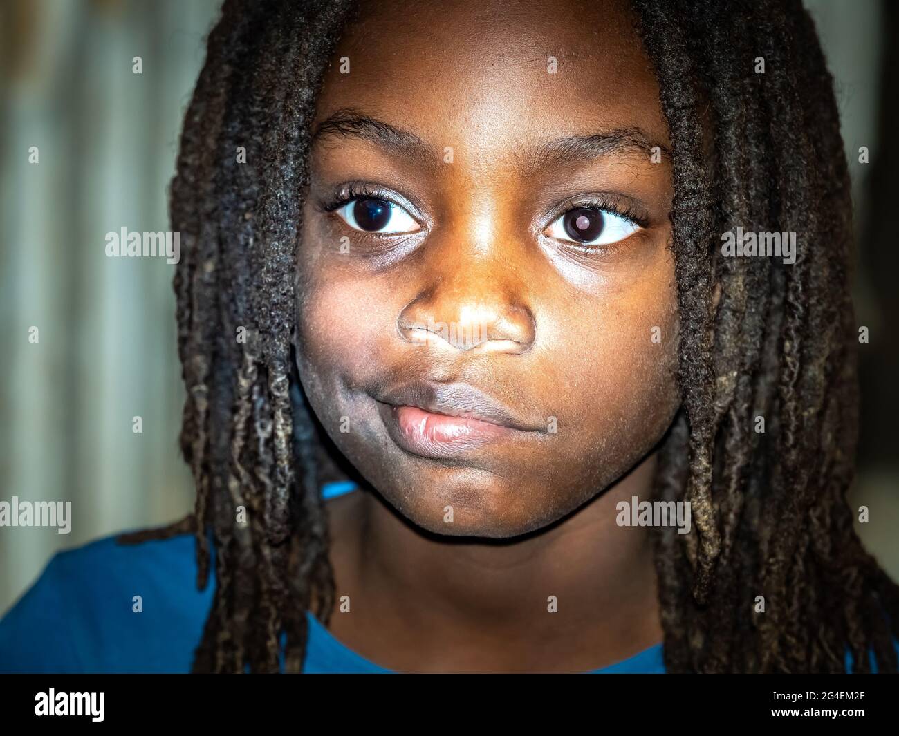 MBOUR, SENEGAL - JANUARY Circa, 2021. Close up unidentified upset thoughtful African boy alone, looking in distance, thinking about teen problem, firs Stock Photo