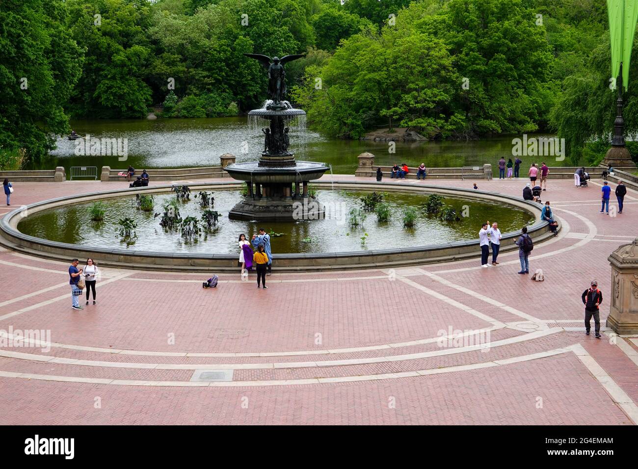 People mingling, posing for photos, around the Belvedere Fountain in