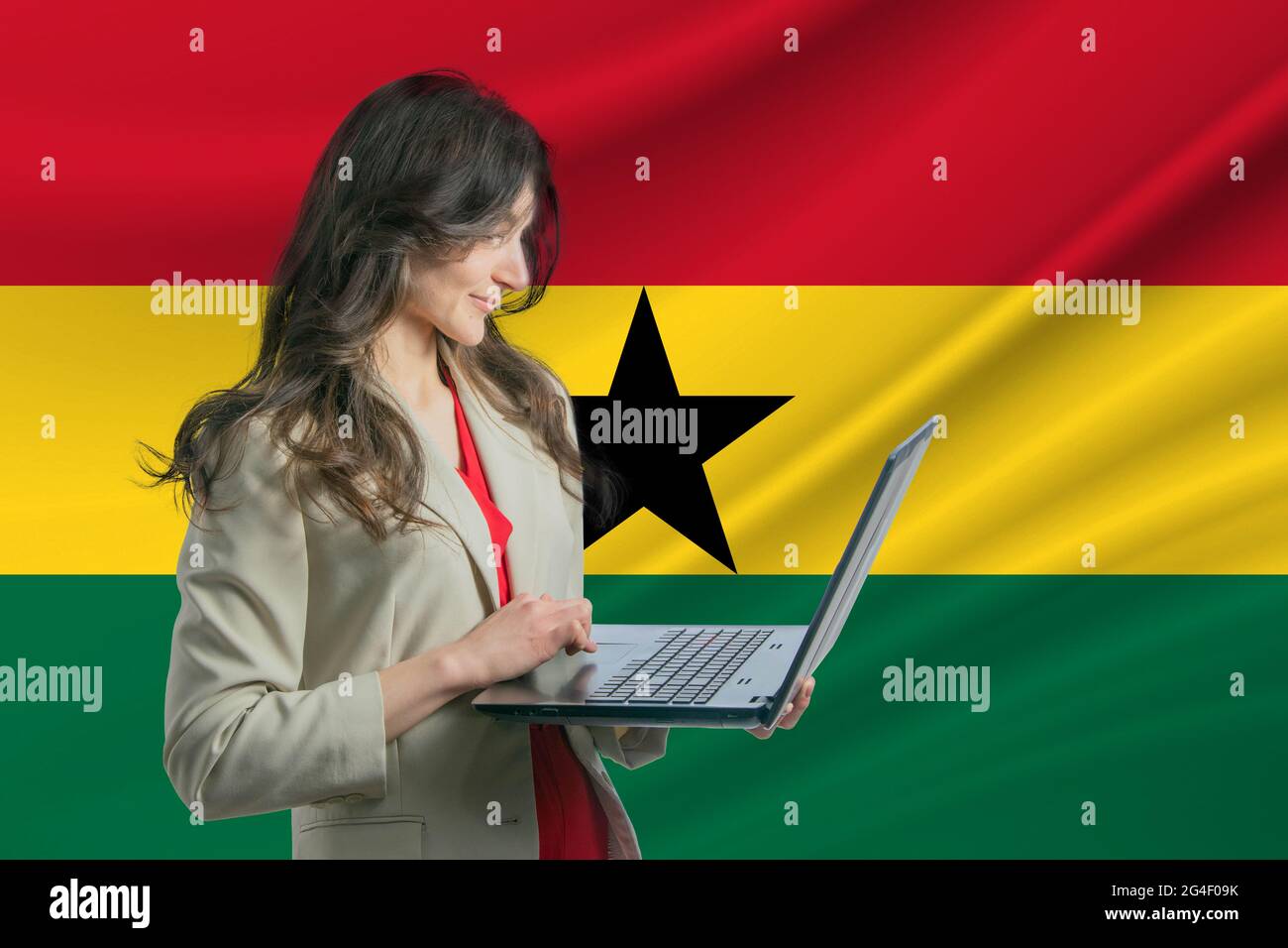 Freelance in Ghana. Beautiful young woman freelancer uses laptop computer against the background