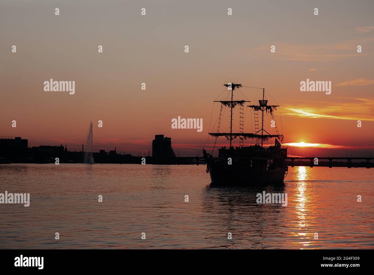 A small boat in a large body of water Stock Photo