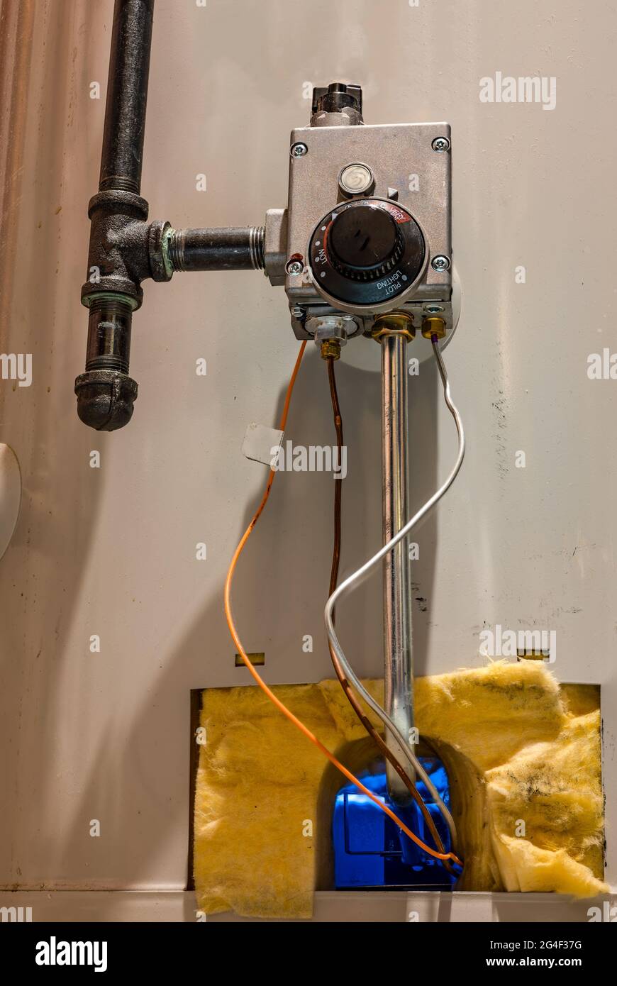 Hot water heater pilot light and burner visible with base plate removed Stock Photo Alamy