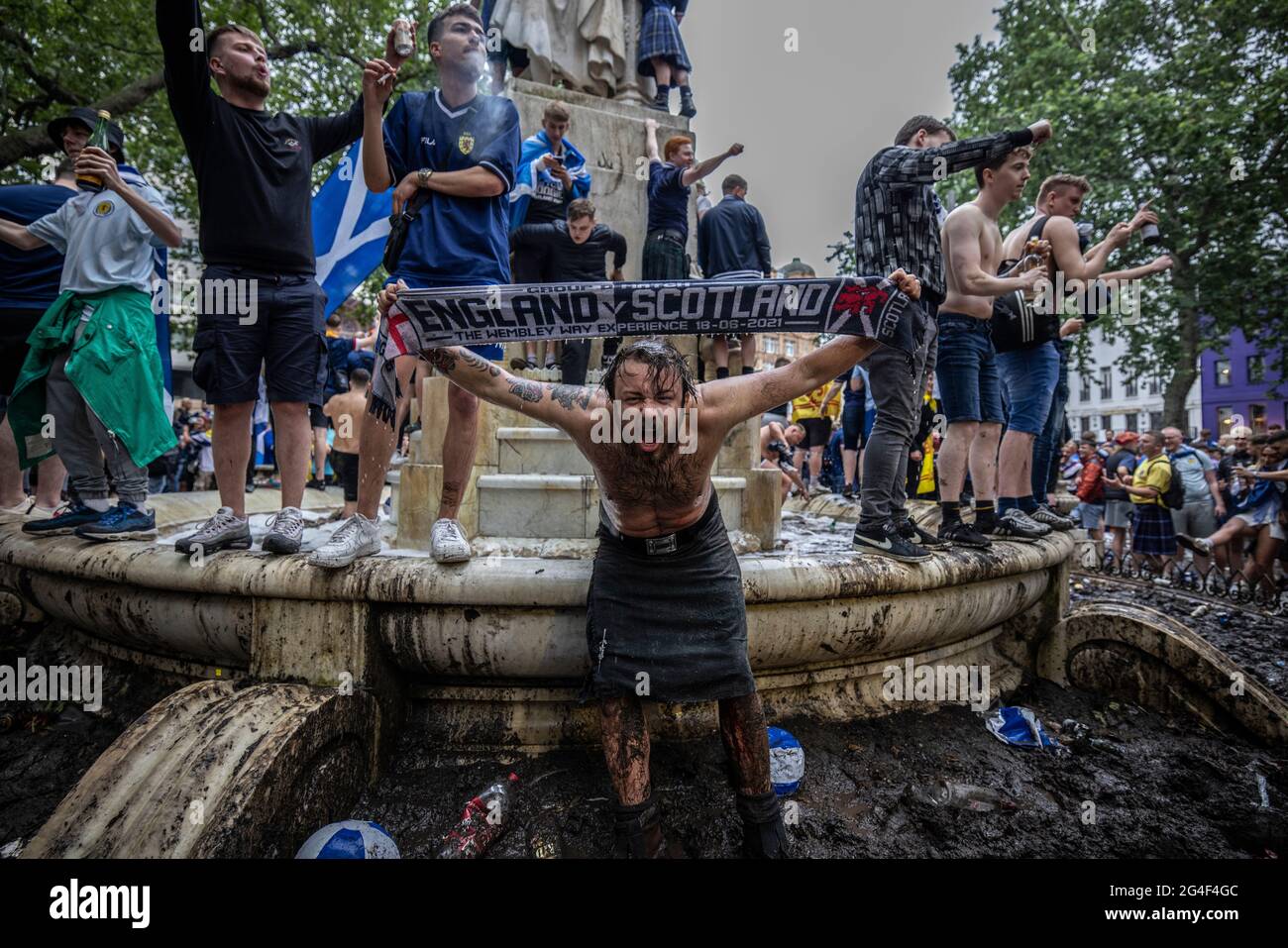 Scottish fans congregate within the William Shakespear fountain in Leicester Square, Central London ahead of the EURO20 match against England Stock Photo