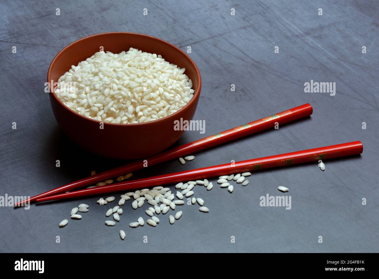 Rice, rice grains in bowl with chopsticks, Germany Stock Photo Alamy