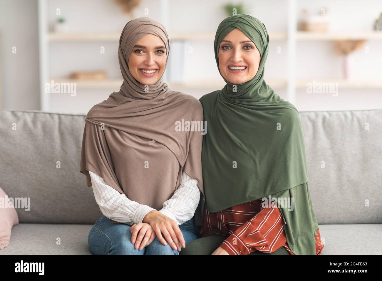 Mature Muslim Lady And Her Adult Daughter Posing At Home Stock Photo