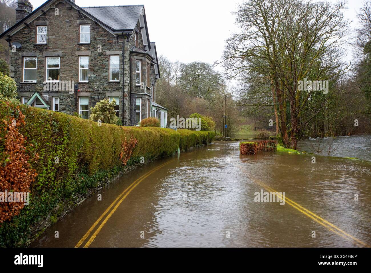 Flooding on the under Loughrigg road in Ambleside from extreme weather, Lake District, UK Stock
