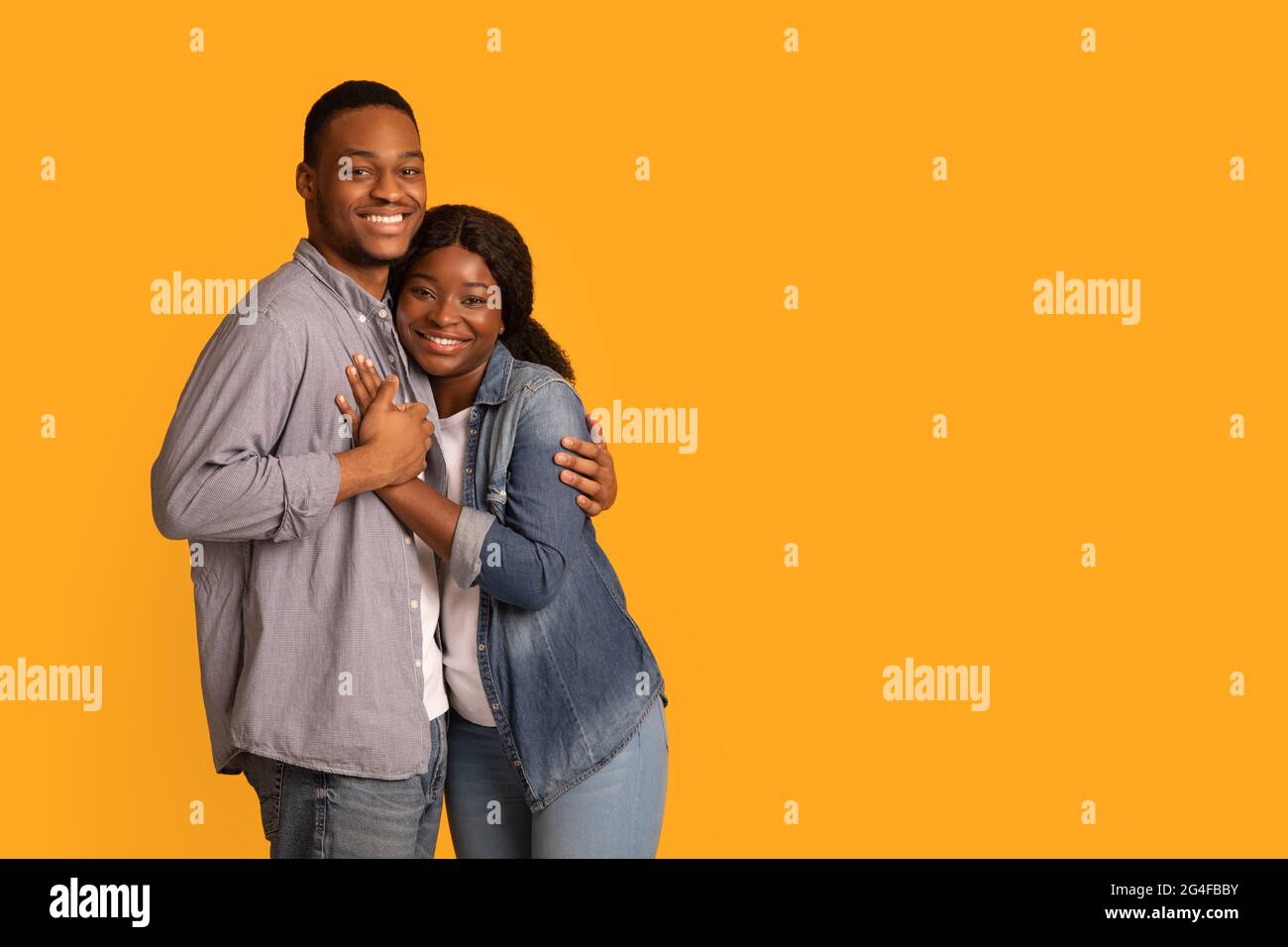 Affectionate young African American man hugging his wife at home Stock ...