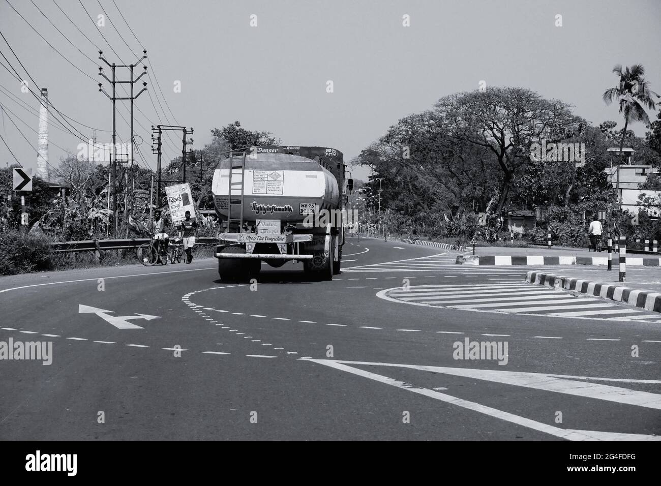HOWRAH, WEST BENGAL, INDIA - FEBRUARY 24TH, 2018 : A petrol carriage truck is carrying petrol on the highway in daytime. Black and white image. Stock Photo