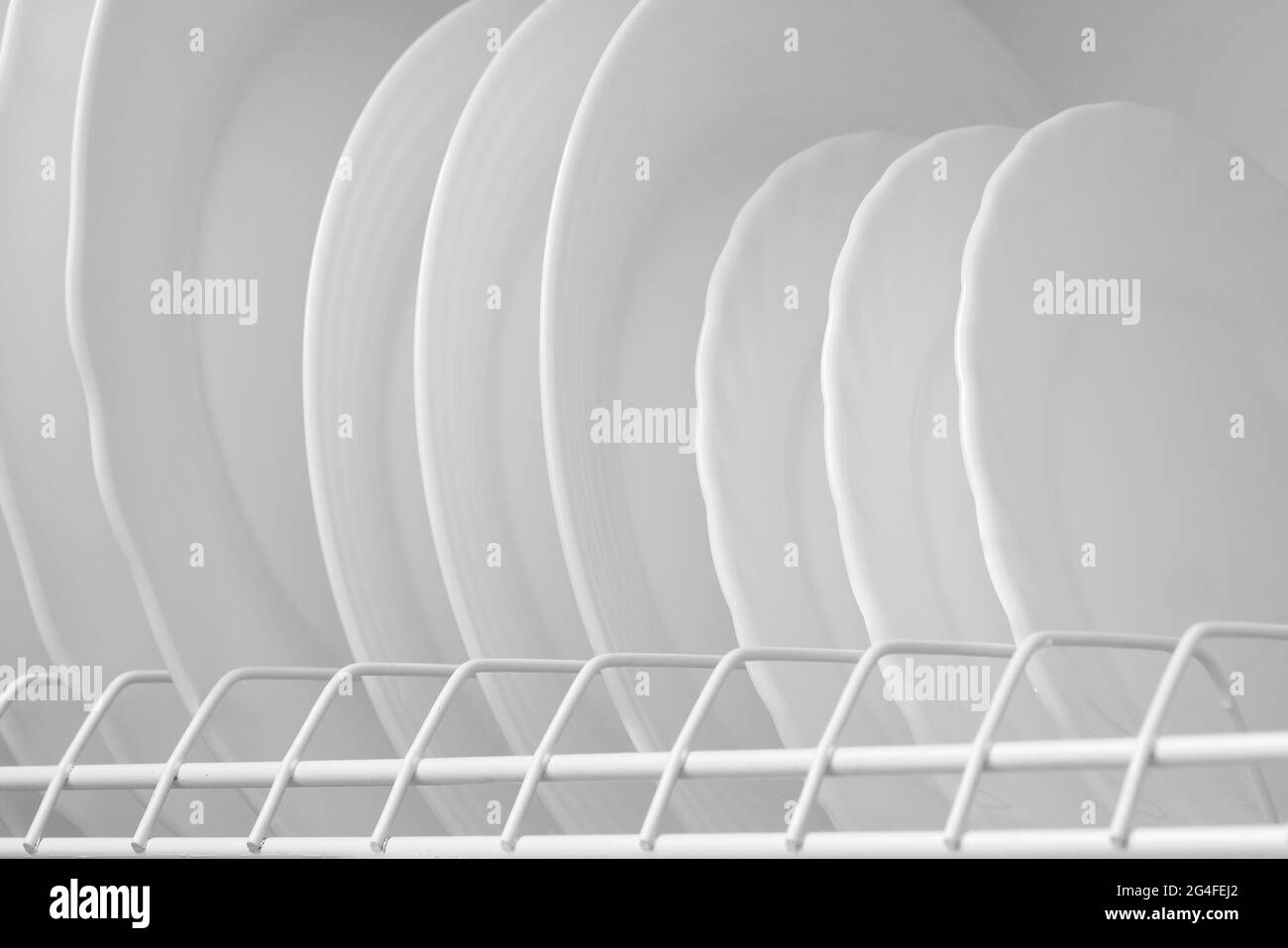 Clean white plates on dish drainer drying after washing Stock Photo Alamy