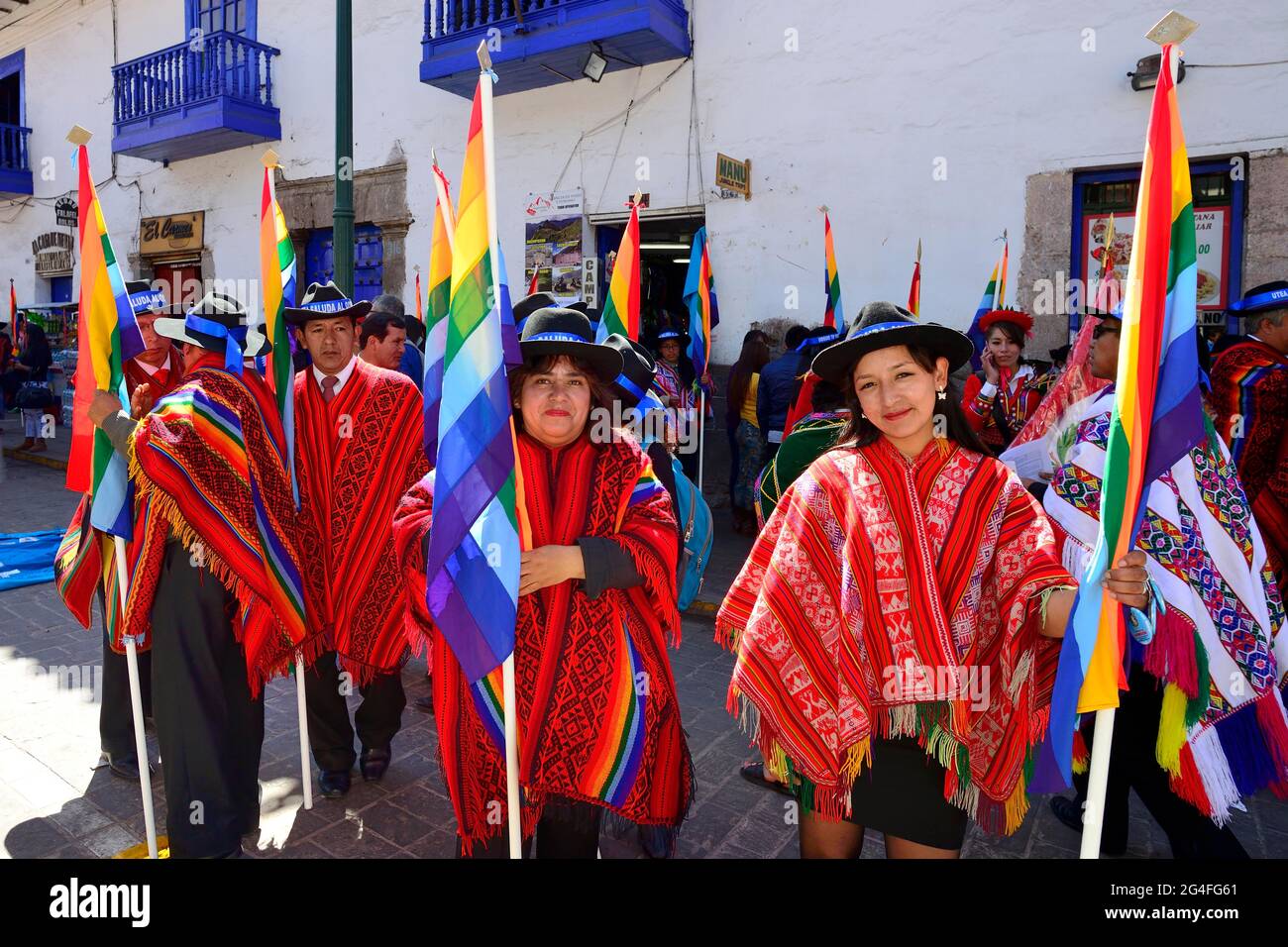 Group with flags in ponchos in the old town, Cusco, Peru Stock Photo