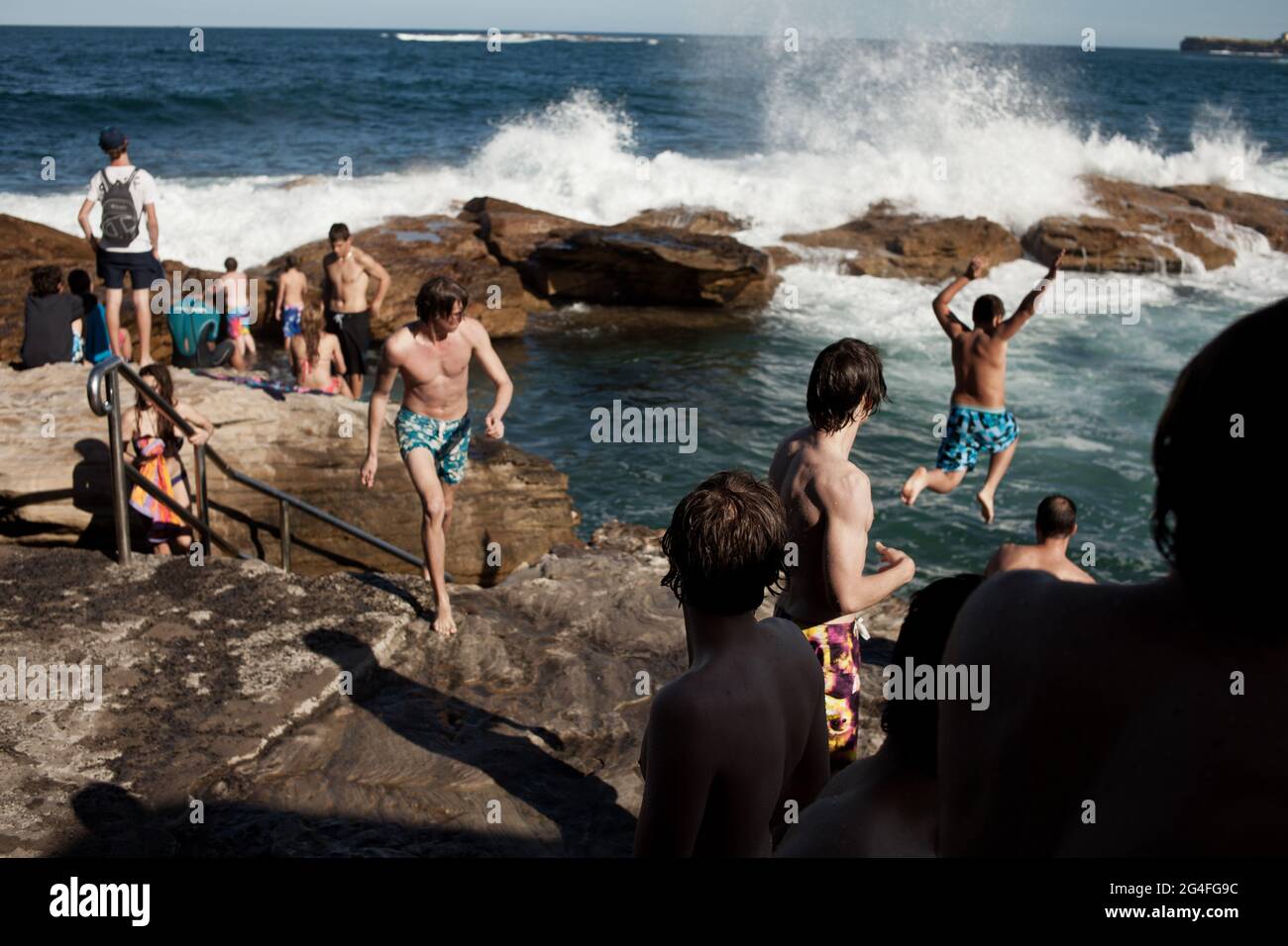 People relaxing and swimming at the Giles Baths in Coogee beach, by the