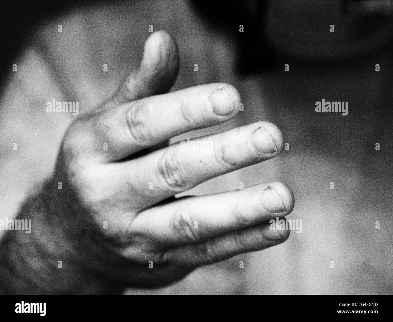 monochrome image of a hand reaching out Stock Photo