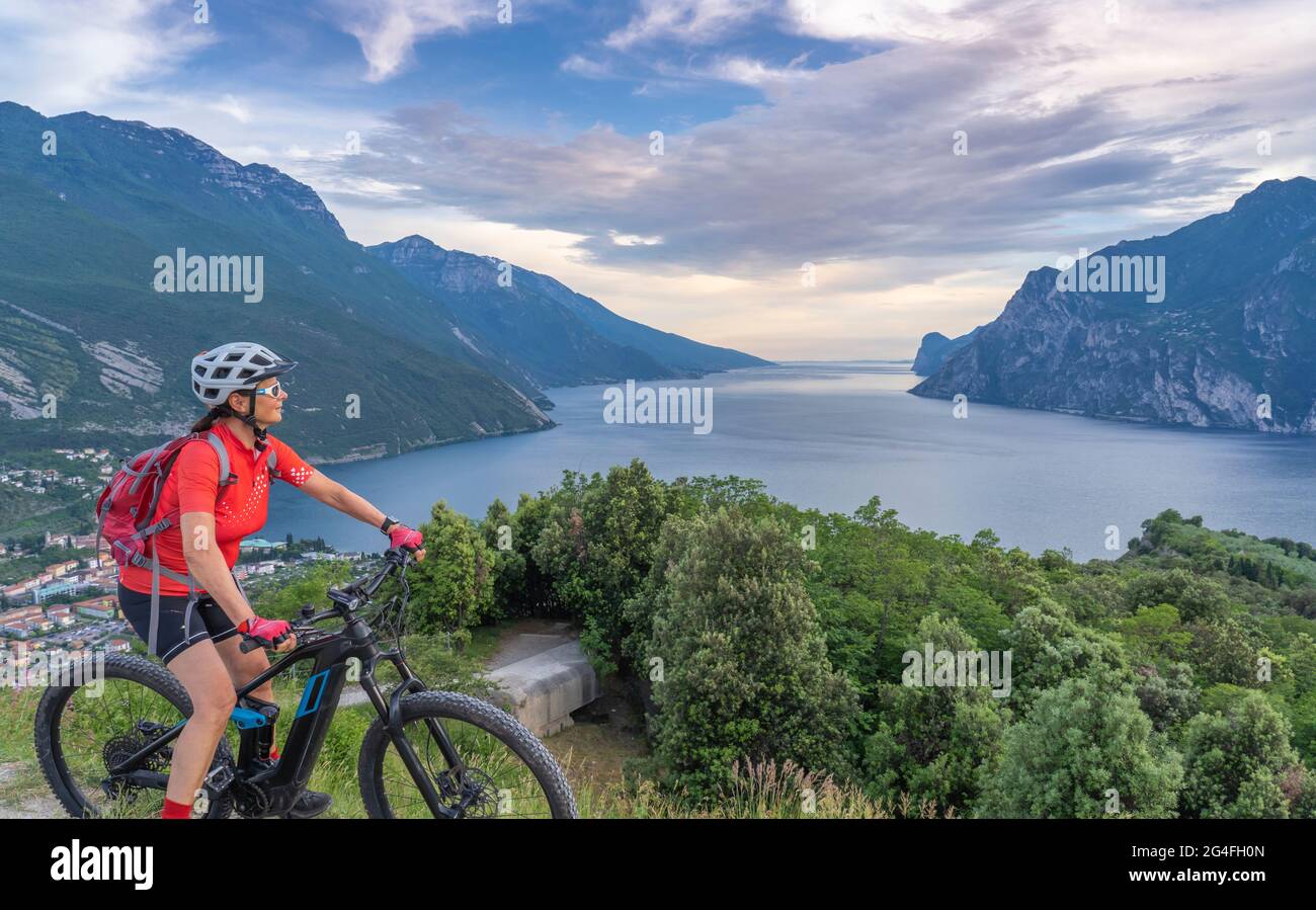 nice senior woman with electric mountain bike resting on Mt Brione enjoying  awesome view over Garda Lake between Riva del Garda and Torbole Italy Stock  Photo - Alamy
