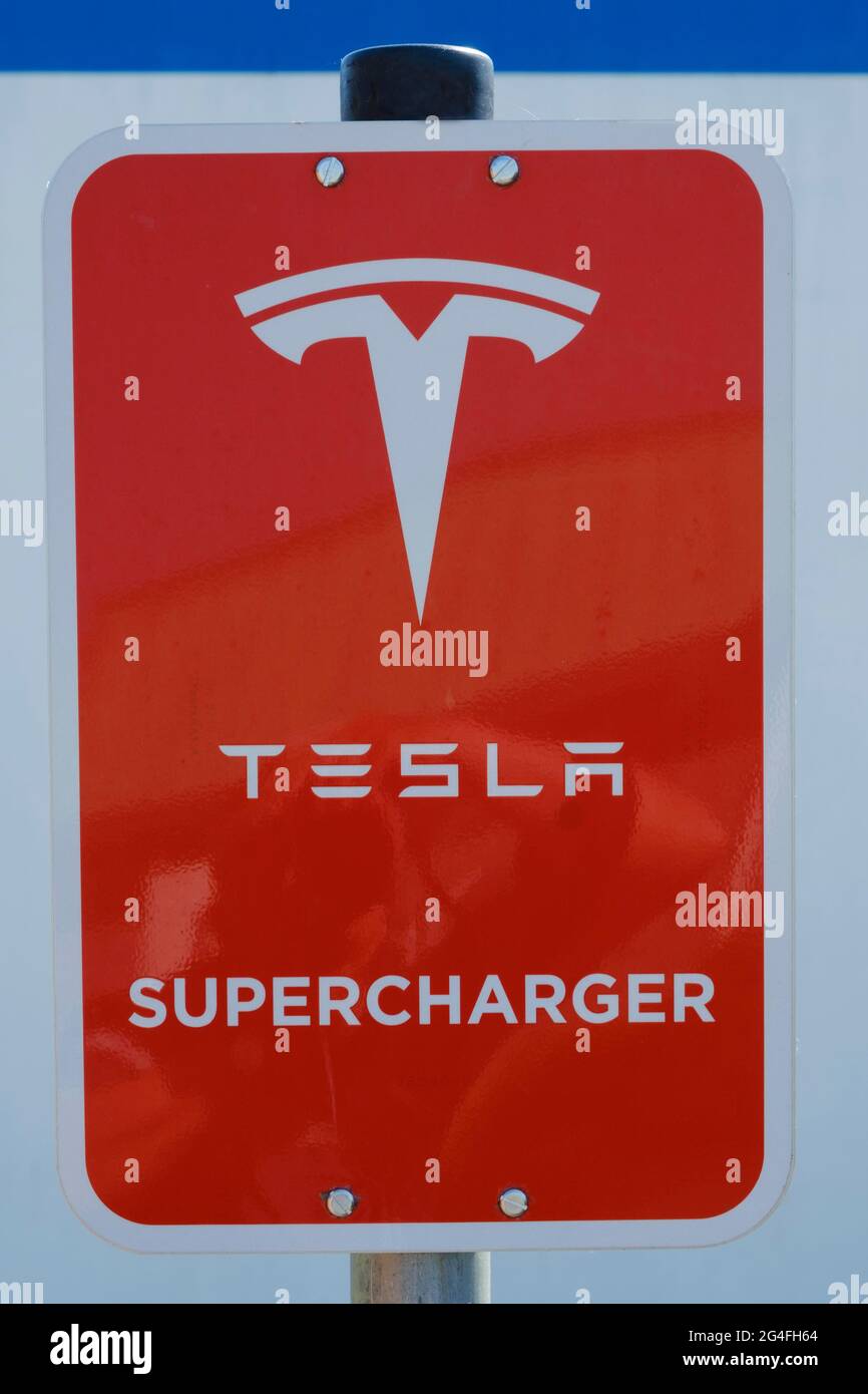 Sign and logo Tesla Supercharger, fast charging station for electric