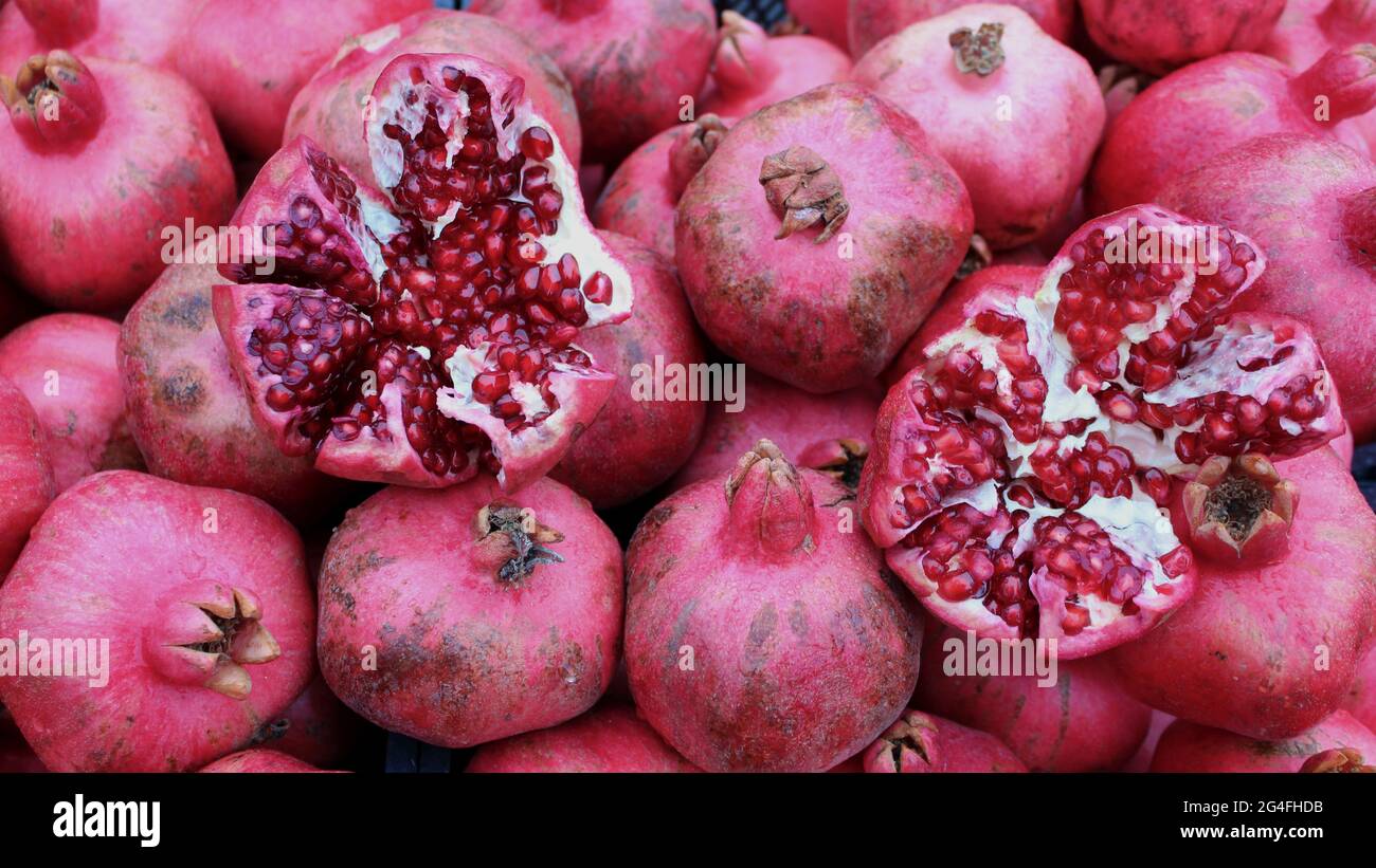 Juicy and ripe pomegranates. Ruby natural pomegranate slices and pomegranate  fruit seeds Stock Photo - Alamy