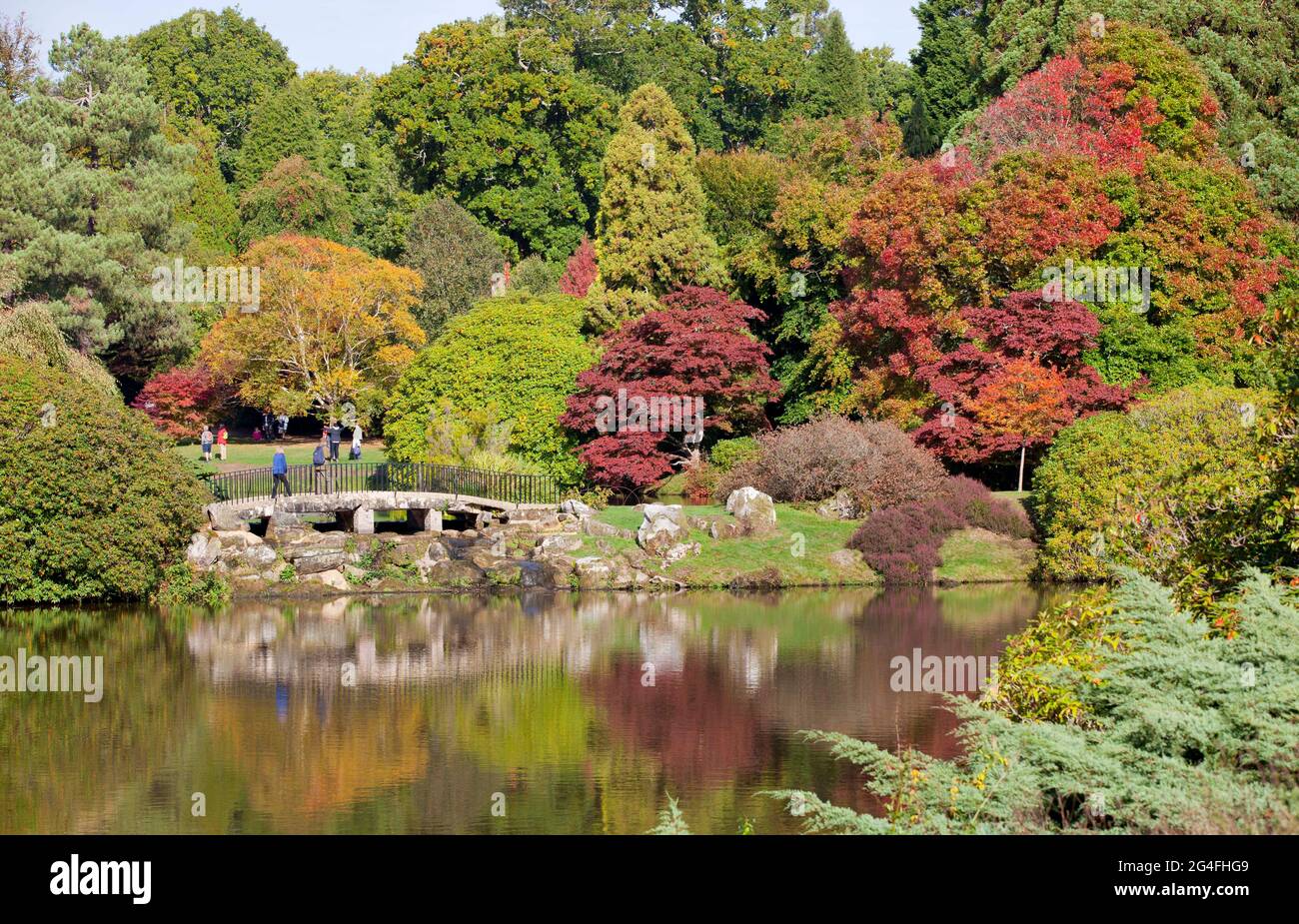 Visitors enjoy the glorious autumnal beauty on display at Sheffield Park and Gardens in East Sussex, England, October 2020.  Famous for its autumn col Stock Photo