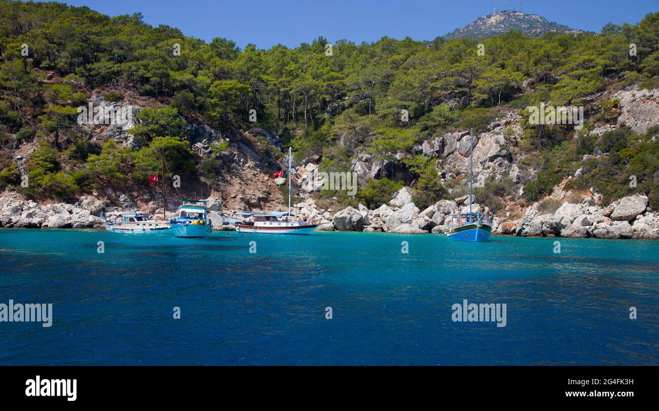 Charter boats moored in a secluded area in the bay of  Kalkan, Turkey.  Kalkan is a popular holiday destination and is located on the Turkish Mediterr Stock Photo