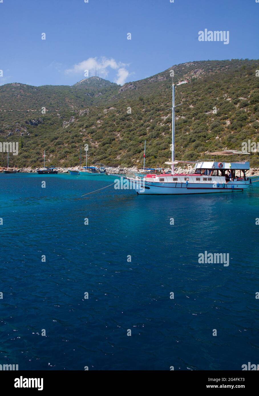 Charter boats moored in a secluded part of the bay of Kalkan in Turkey.  Kalkan is a popular holiday destination and is located on the Turkish Mediter Stock Photo