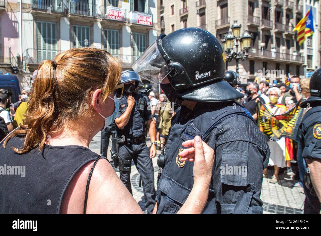 June 21, 2021, Barcelona, Catalonia, Spain: Protester is seen talking to police.Hundreds of Catalan independentistas have demonstrated this Monday, June 21, in Las Ramblas in Barcelona, in front of the Gran Teatre del Liceu (Great Theater of the Lyceum), shielded by many policemen, to protest the visit of the President of the Spanish Government, Pedro Sanchez, who has held a conference entitled ''Reunion: a project for the future for all of Spain'', with the expectation of an imminent granting of pardons for the independence leaders in prison. The protesters protested to denounce that the rep Stock Photo