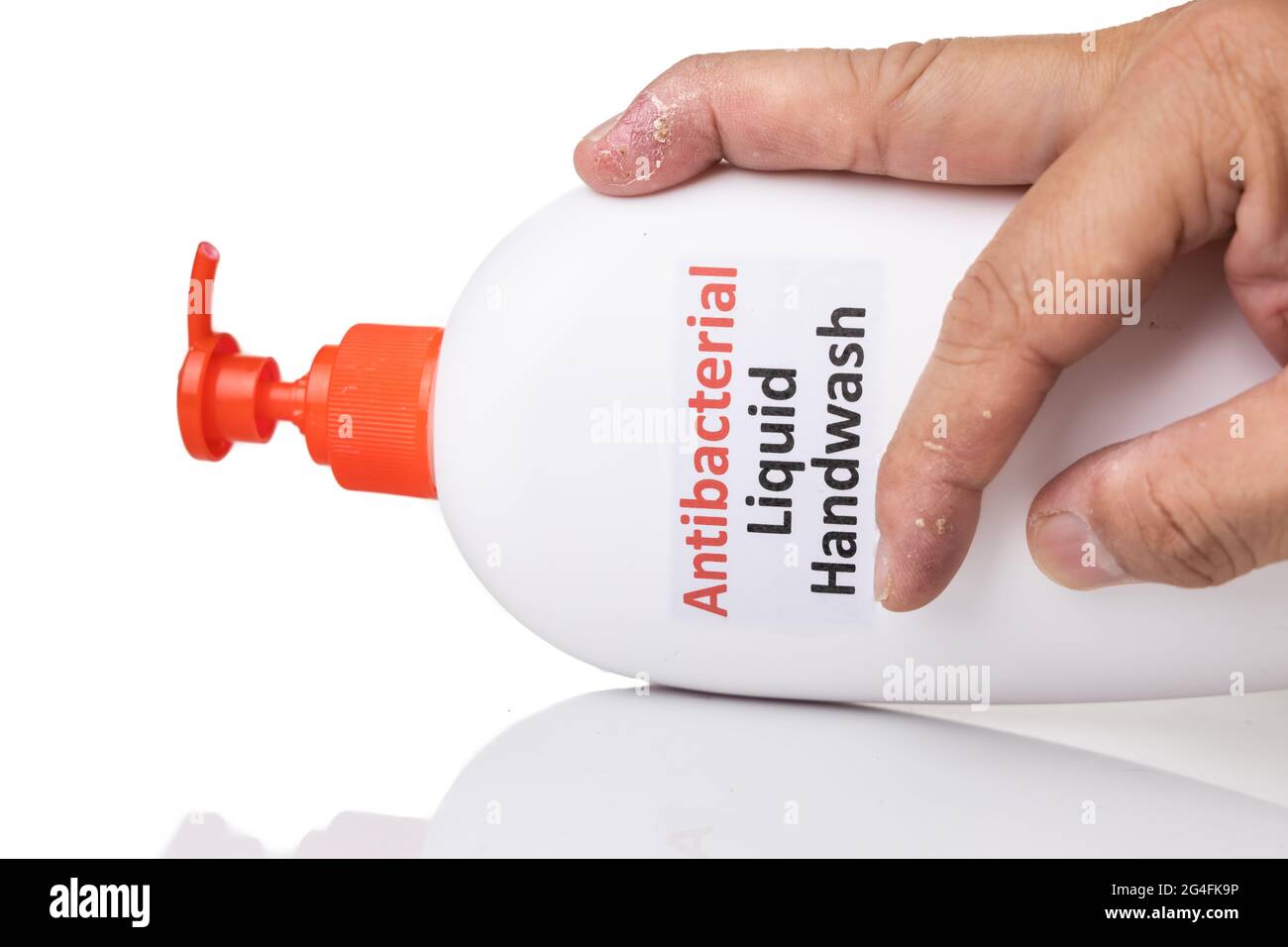 Dry skin on finger with bottle of antibacterial liquid handwash