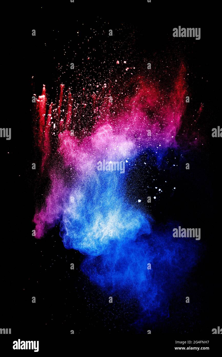 Red blue powder explosion cloud on black background.Launched blue dust particles splash. Stock Photo