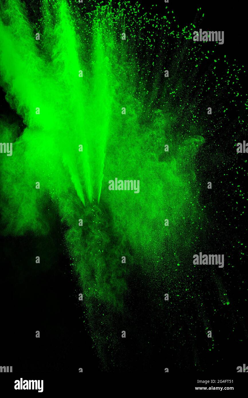 Green color powder explosion cloud  on black background.Green dust splash on background. Stock Photo