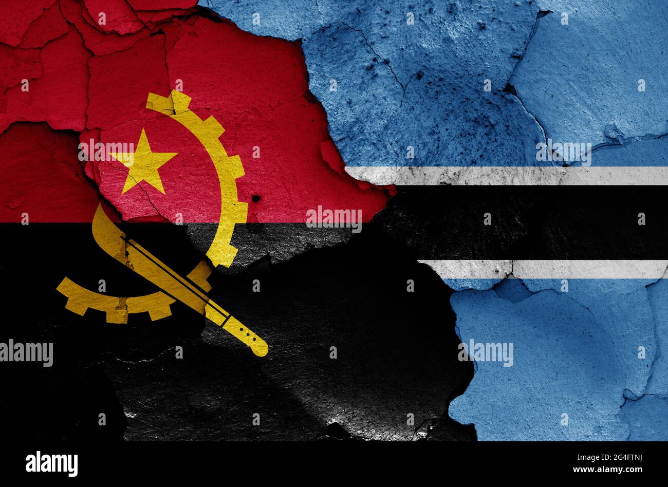 flags of Angola and Botswana painted on cracked wall Stock Photo