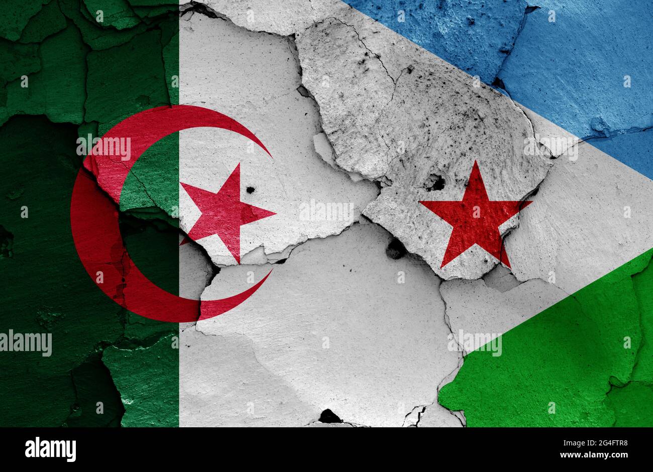 flags of Algeria and Djibouti painted on cracked wall Stock Photo