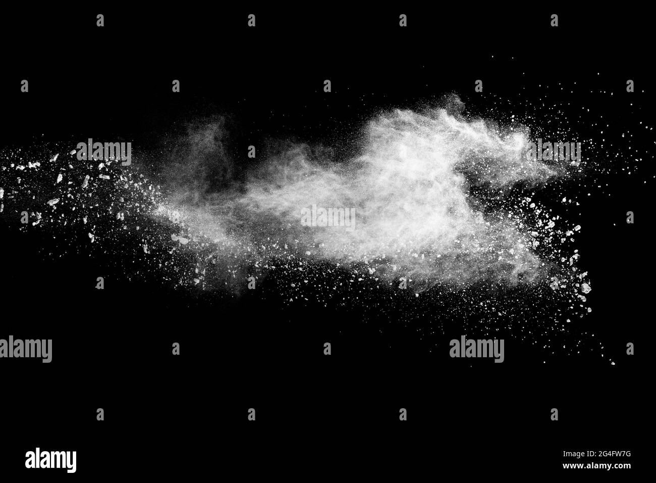 White dust particles splashing. Freez motion of talcum powder burst in dark background. Stock Photo