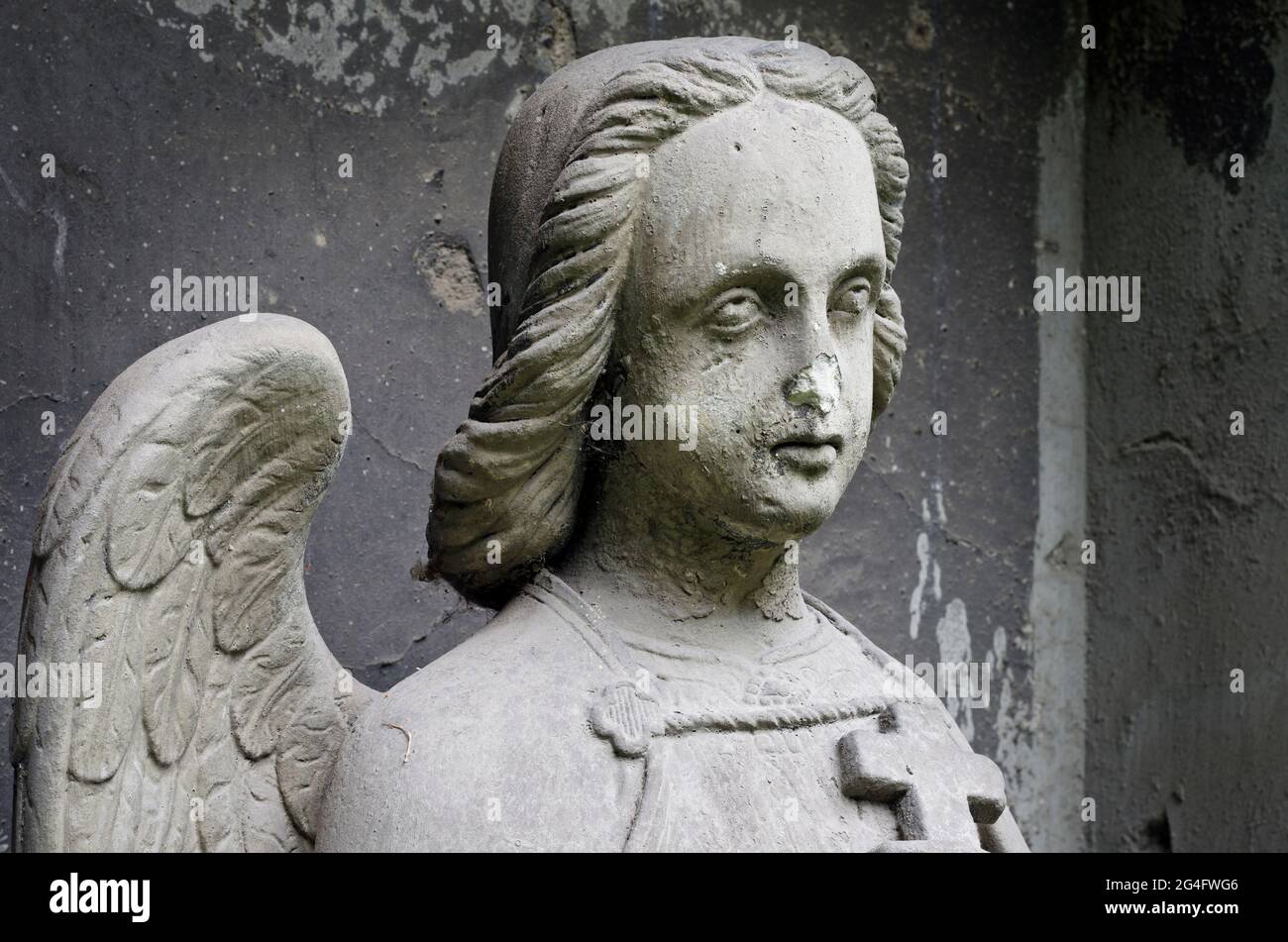 Damaged statue of an Angel with cross - tombstone - old Prague cemetery, Czech republic, Europe Stock Photo