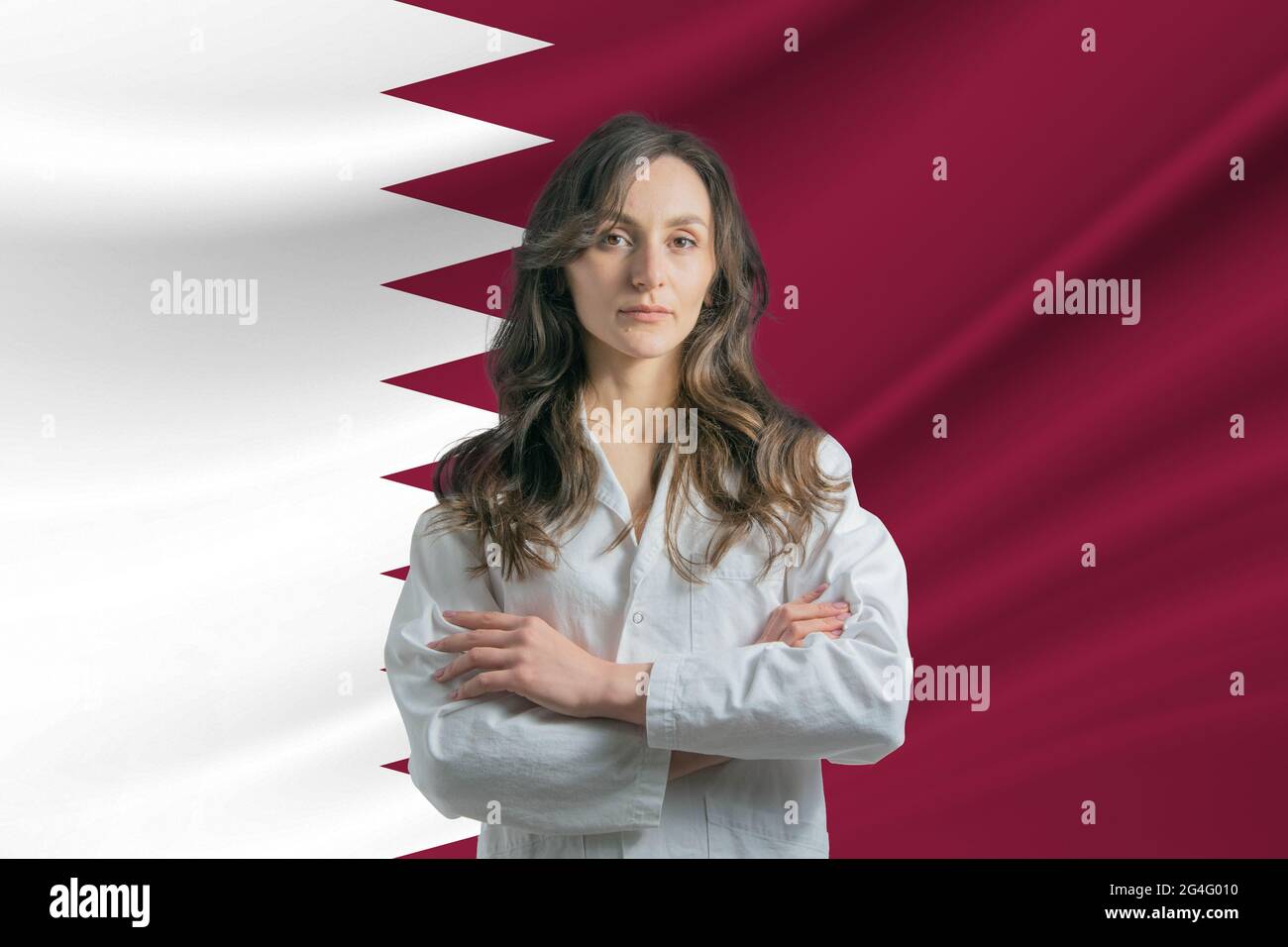 Medicine in Qatar Happy beautiful female doctor in medical coat