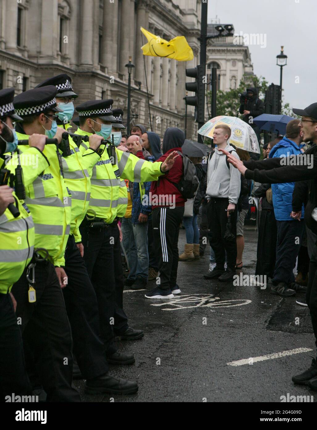 Police officers and protesters at an anti-lockdown protest in Parliament Square, London. Picture date: Monday June 21, 2021. Stock Photo