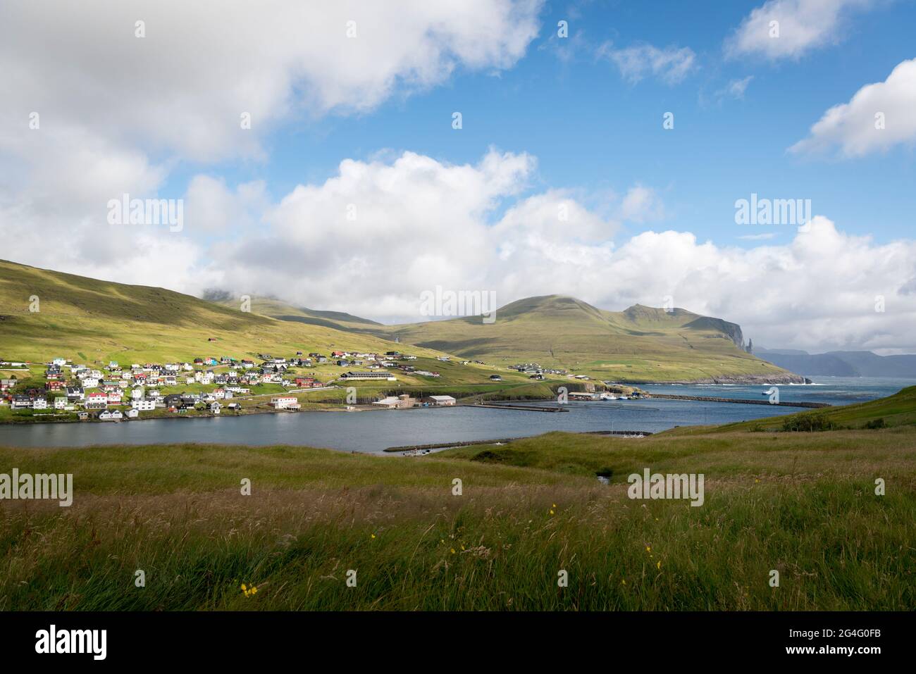 The settlement of Miðvágur as seen from the clifftop path near lake Sorvagsvatn, Faroe Islands Stock Photo