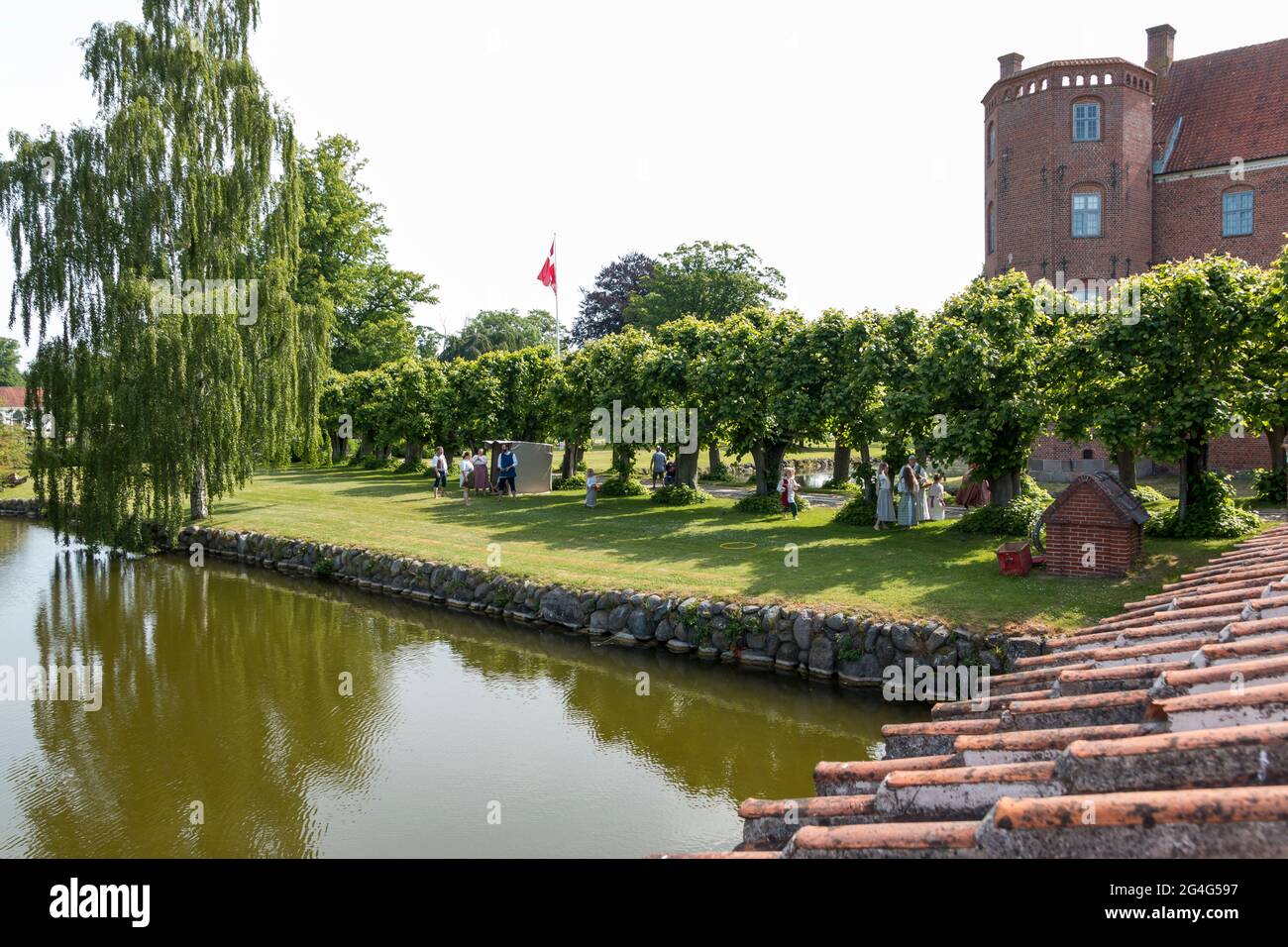 Auning, Denmark - 19 June 2021: Gammel Estrup Castle from the 14th century, The castle is surrounded by beautiful nature, trees and lakes and moat Stock Photo