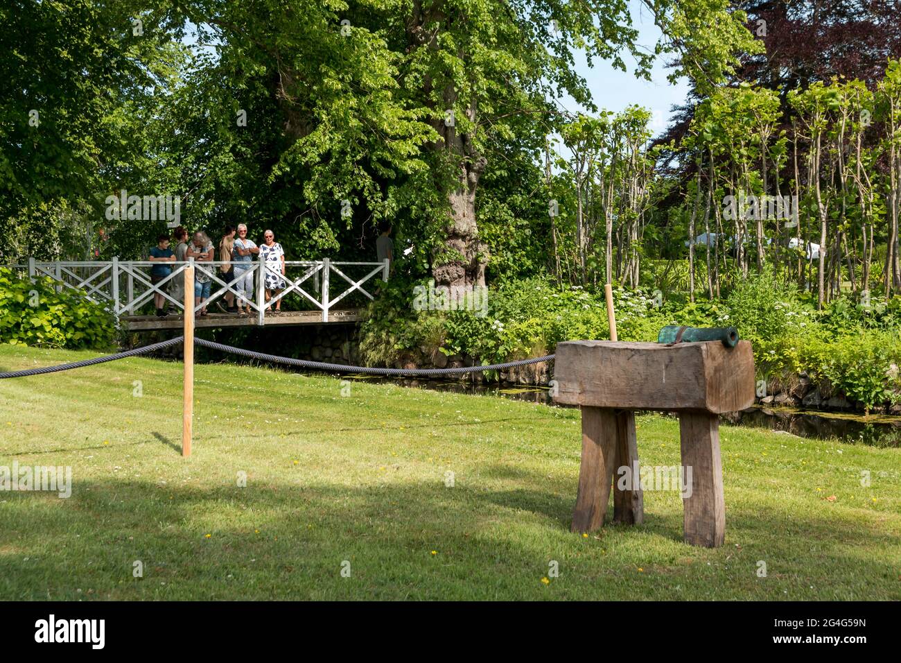 Auning, denmark - 19 June 2021: 18th century day at Gammel Estrup Castle, Old cannon to make signal blasts with, tree and metal, bronce cannon Stock Photo