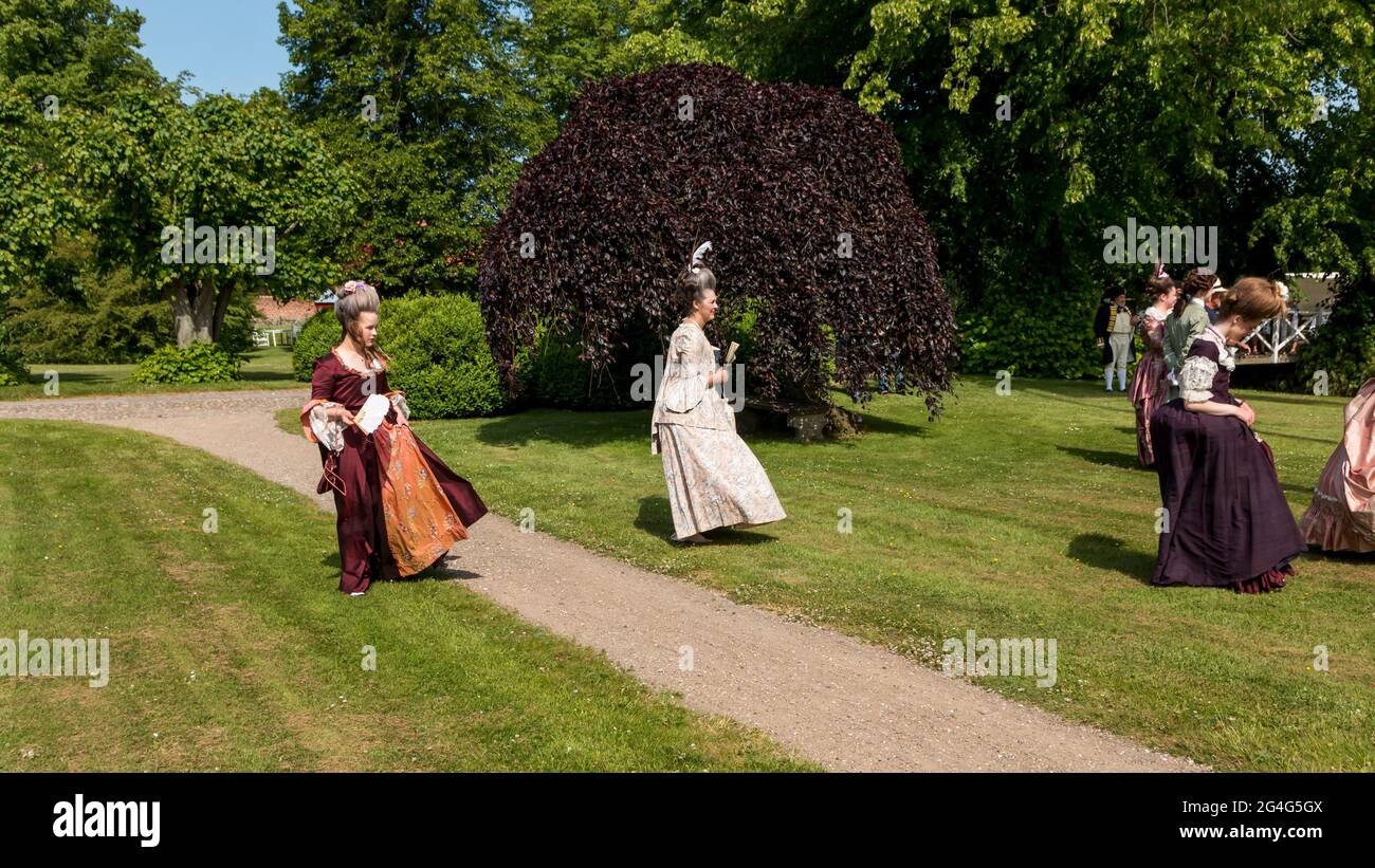 Auning, Denmark - 19 June 2021: 18th century day at Gammel Estrup Castle, People are dressed as in the 18th century and everything passes as then. Wom Stock Photo