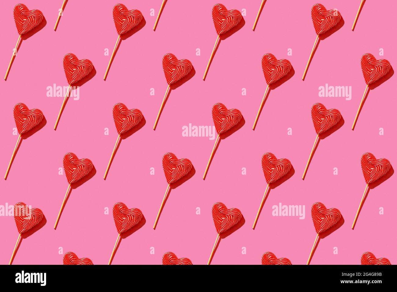 Lollipop heart shaped candy pattern, top view. Stock Photo
