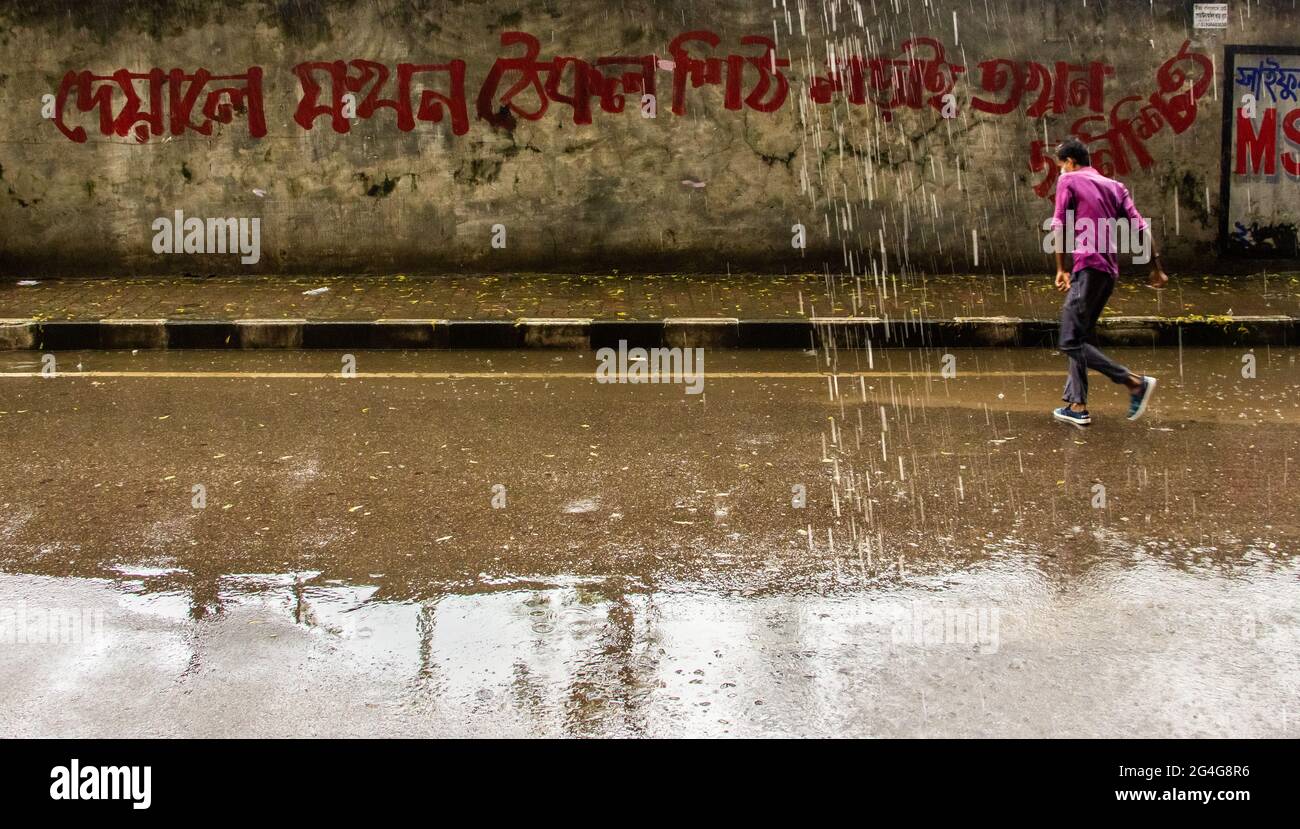 A pedestrian walking with an umbrella on a rainy day. I captured this ...