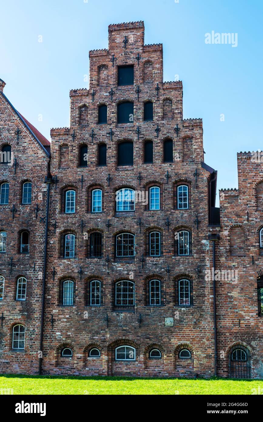 Facade of the medieval salt warehouses or Salzspeicher next to Holsten Gate or Holstentor in Lübeck, Germany Stock Photo