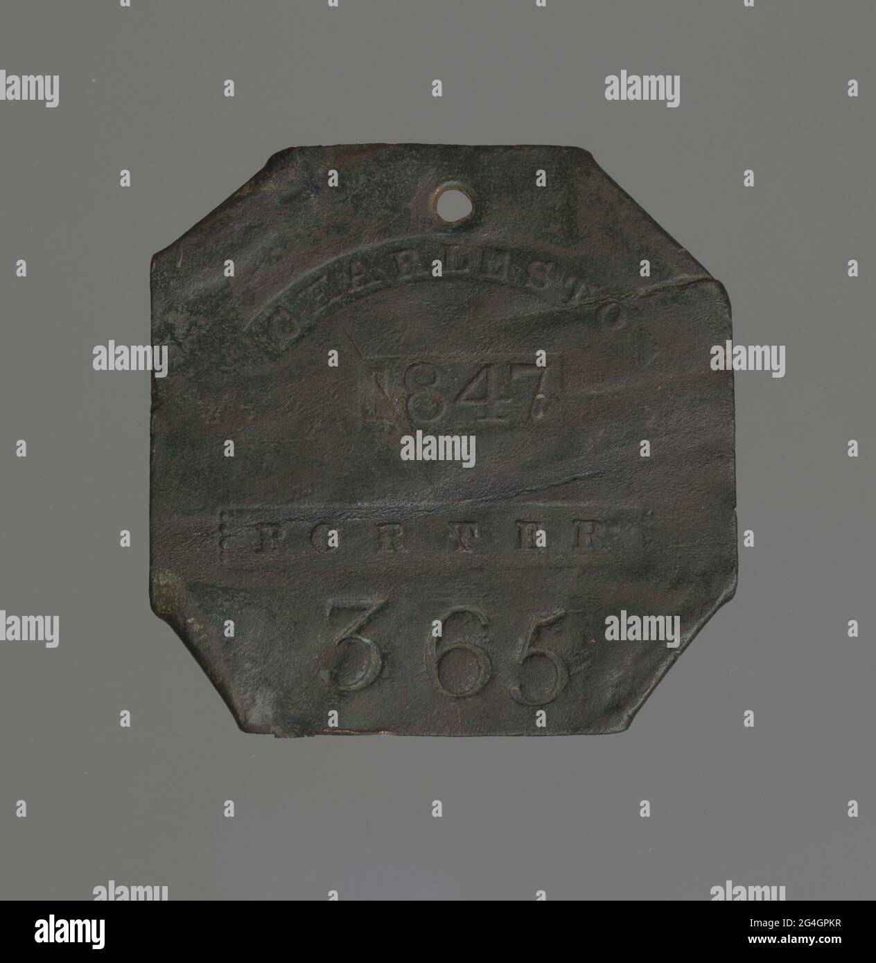 Discolored copper square with corners folded behind and an attachment hole on the top. Die stamped: &quot;CHARLESTON / 1847 / PORTER / 365.&quot; Stock Photo
