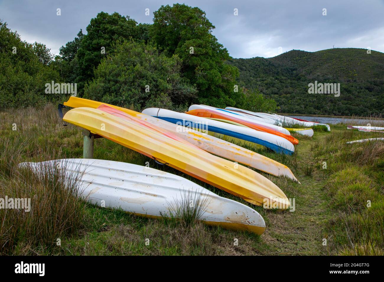 Upside down canoes on grass land next to a river in South Africa Stock Photo Alamy